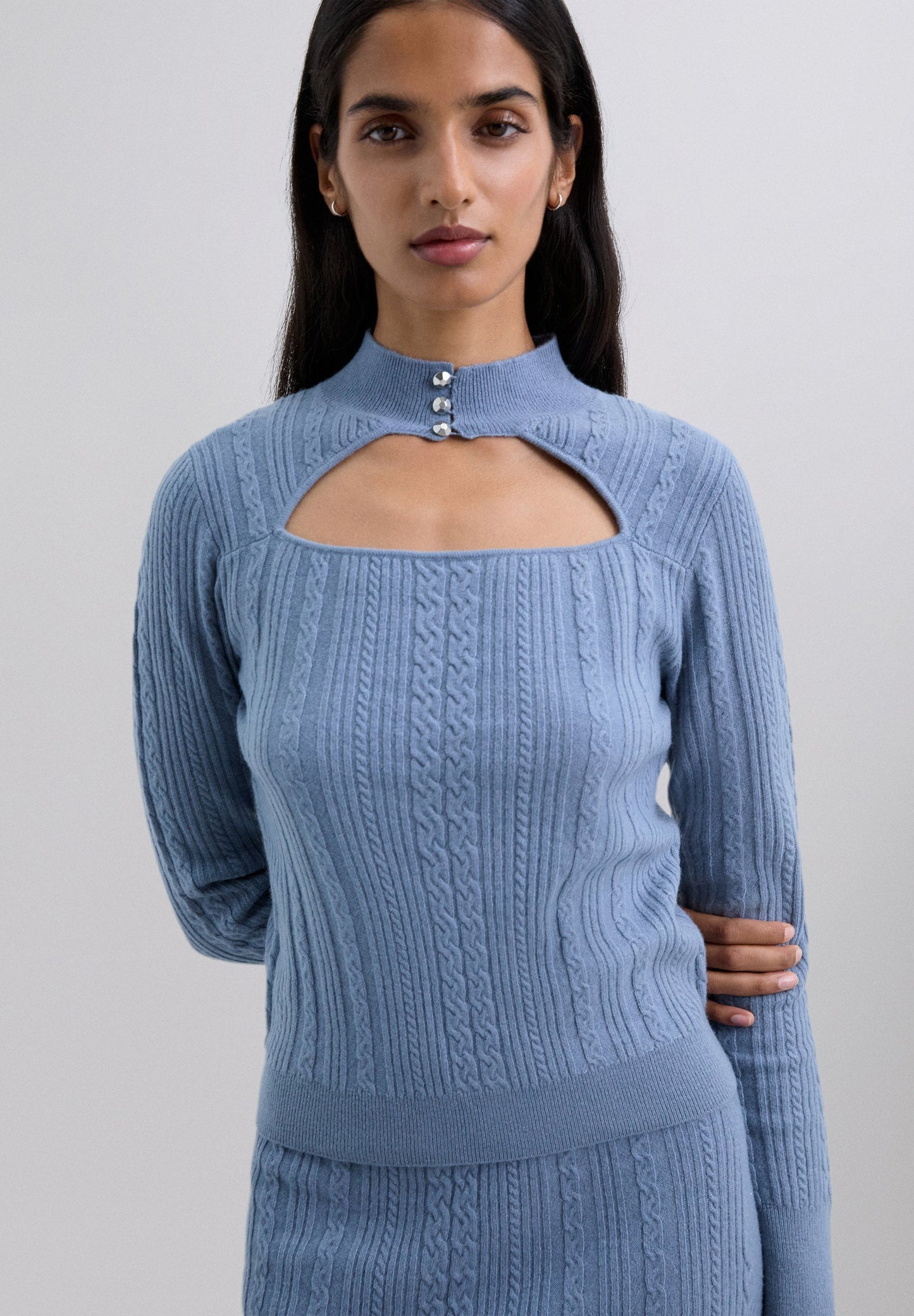 CABLE KNIT SWEATER WITH CUT-OUT