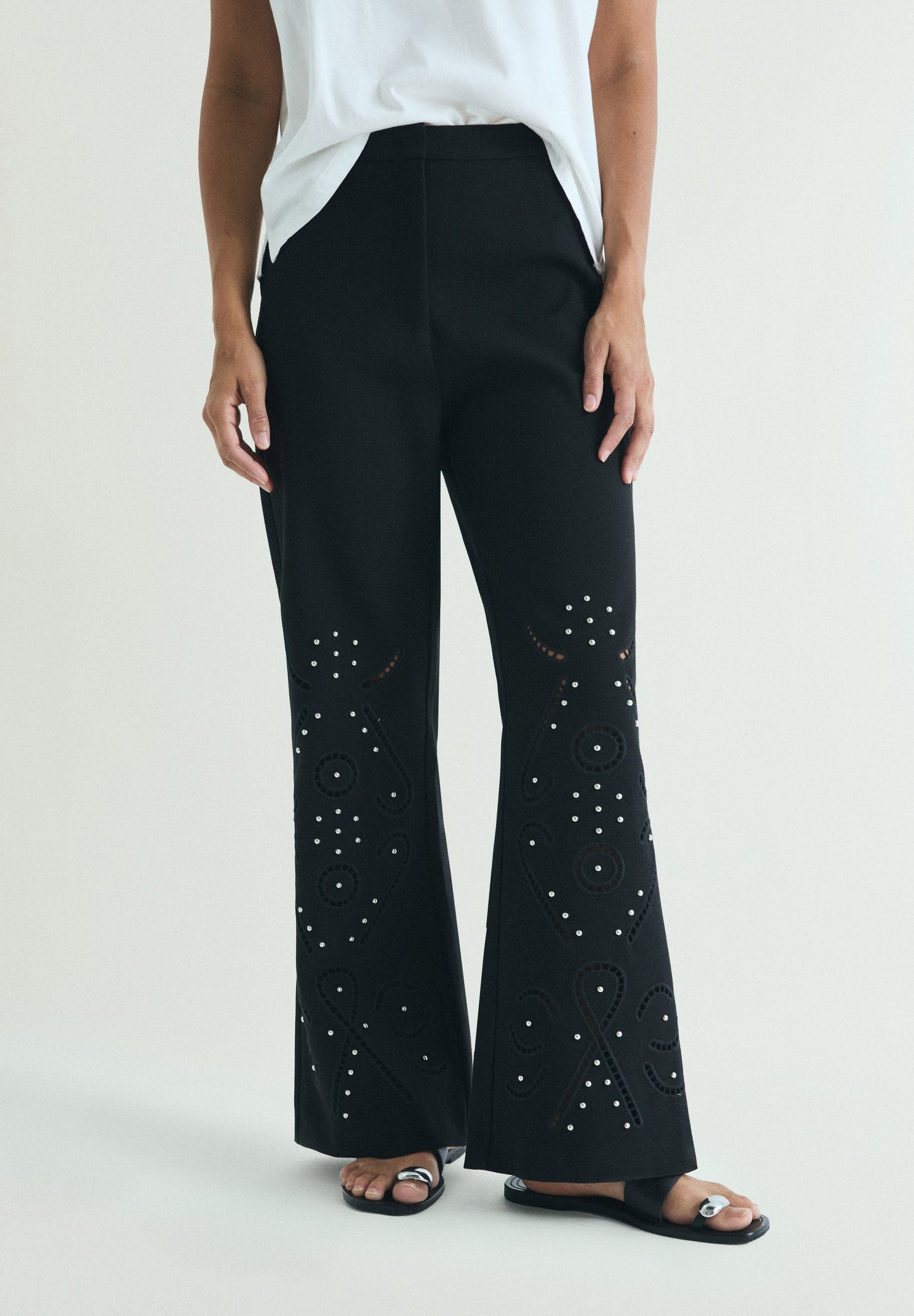 TROUSERS WITH PERFORATED DETAILS