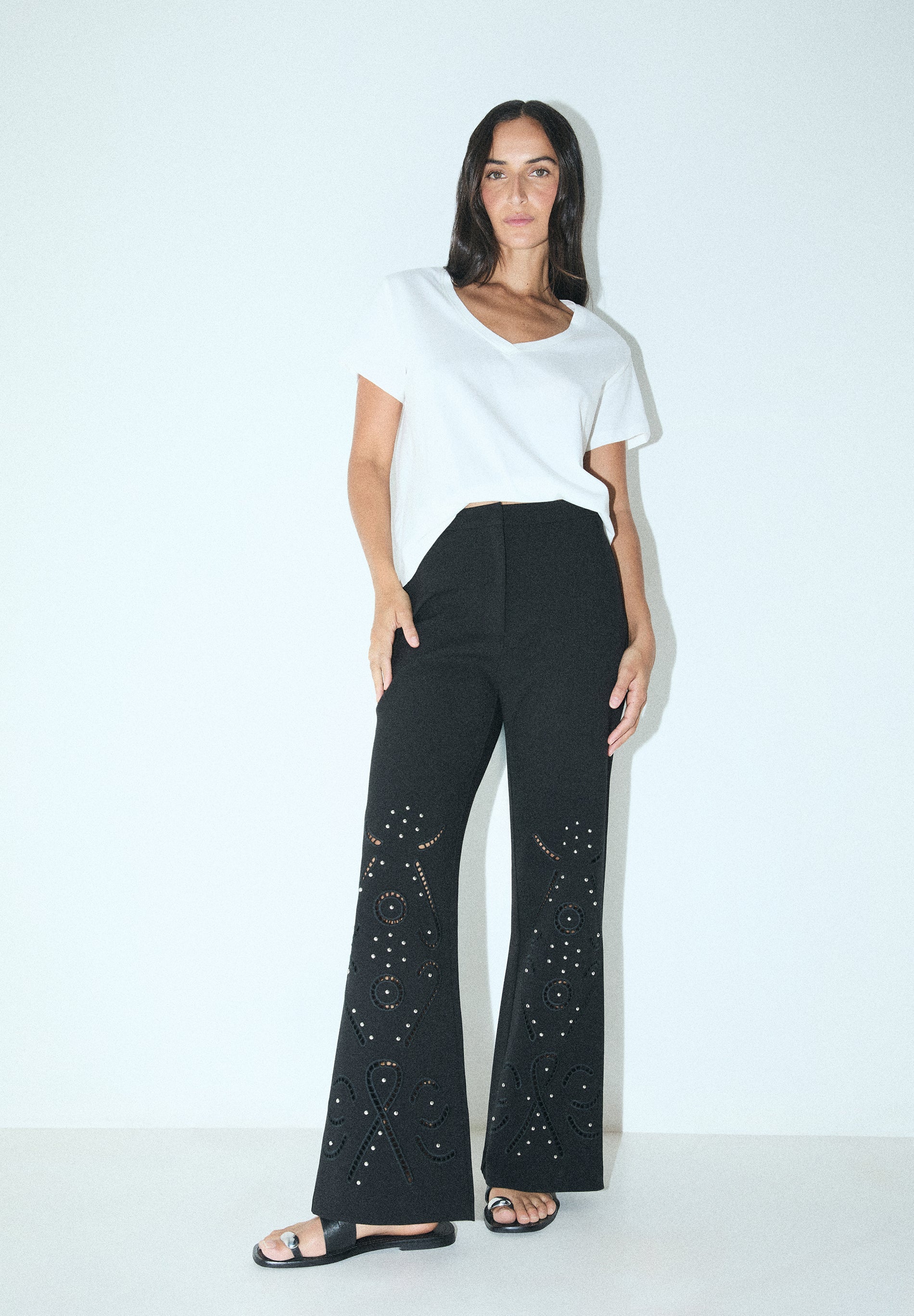 TROUSERS WITH PERFORATED DETAILS