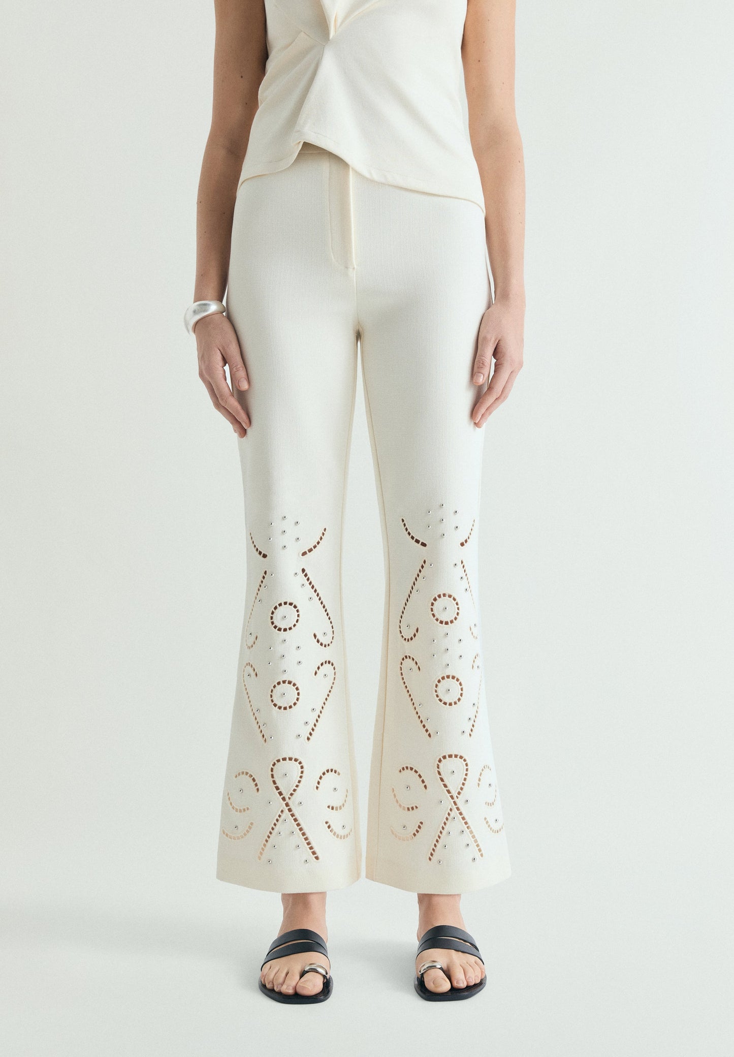 TROUSERS WITH PERFORATED DETAILS