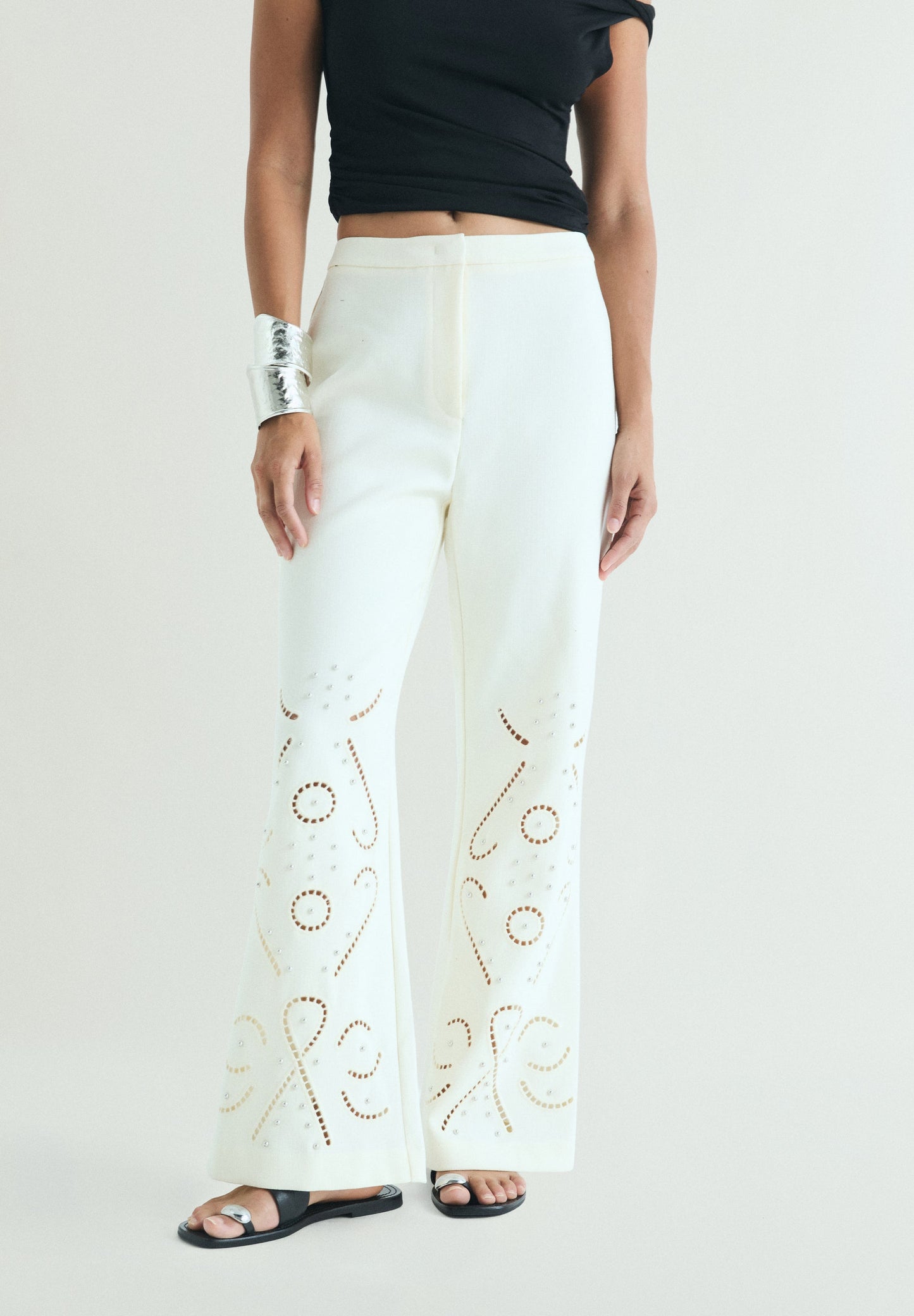 TROUSERS WITH PERFORATED DETAILS