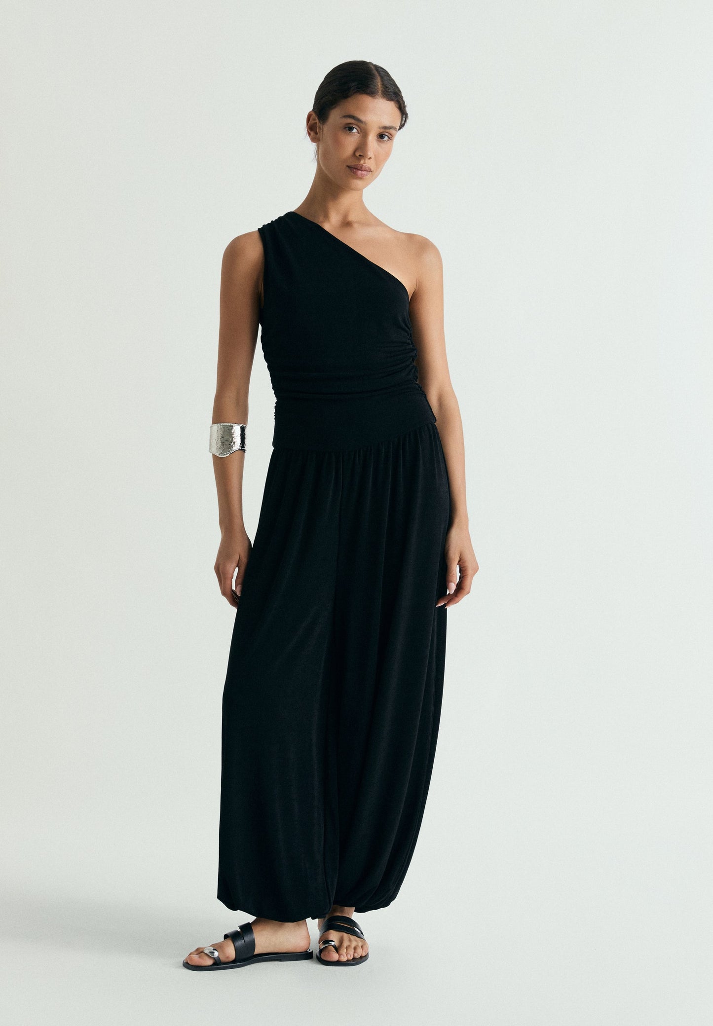 DRAPED ASYMMETRIC JUMPSUIT