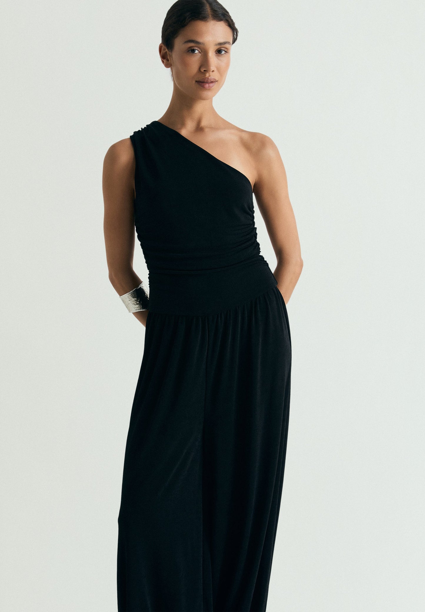 DRAPED ASYMMETRIC JUMPSUIT
