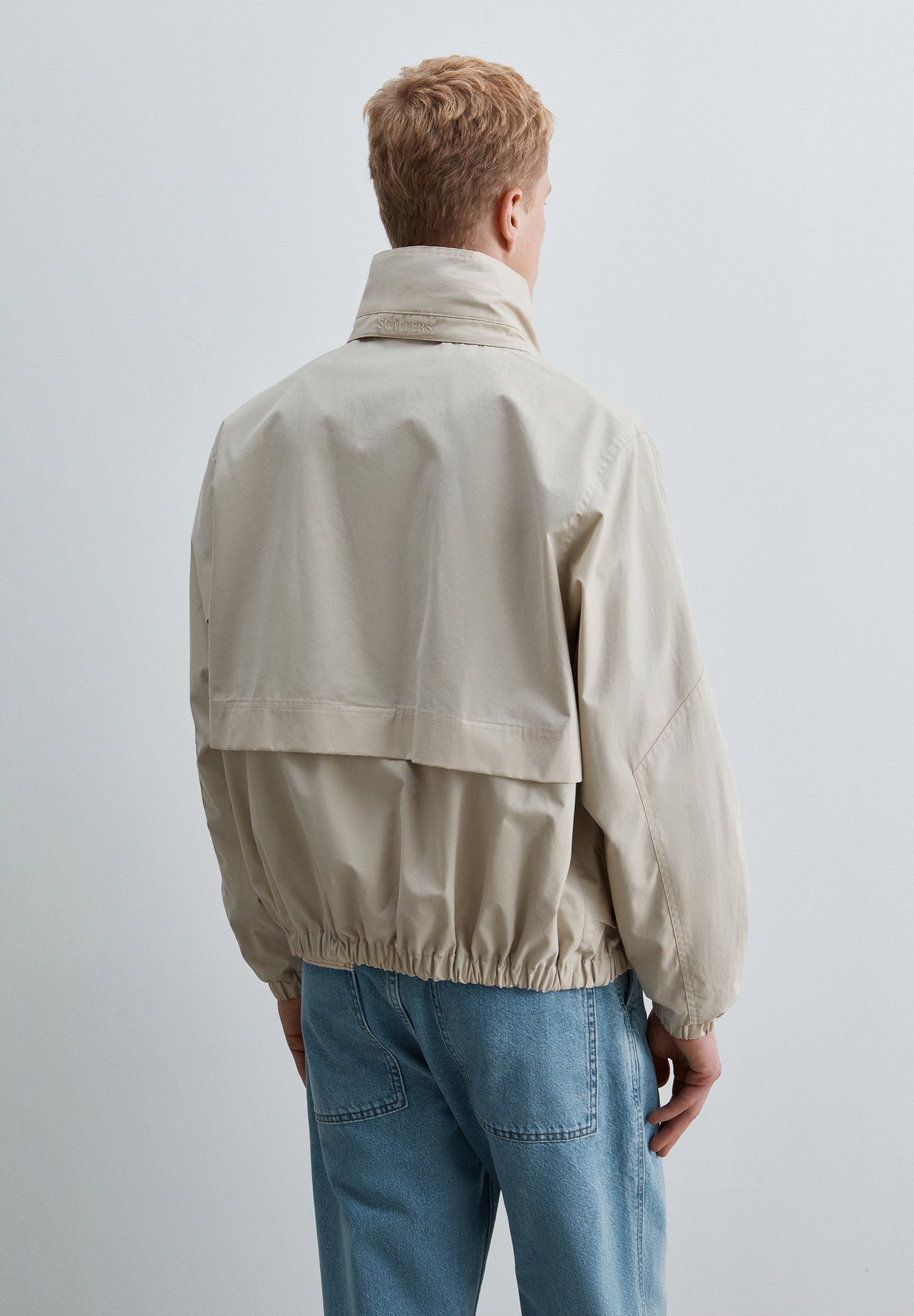 TECHNICAL JACKET WITH CONCEALED HOOD